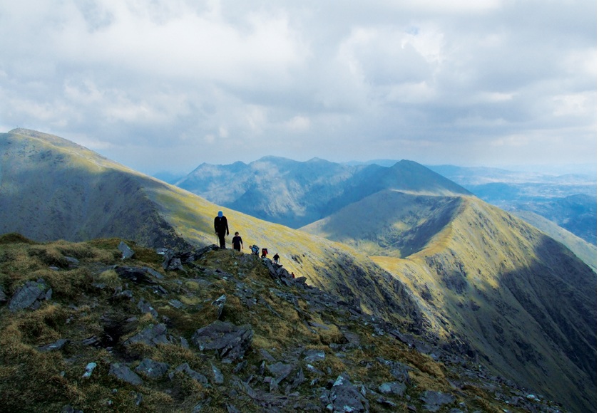 Hiker overlooking Irish valleys